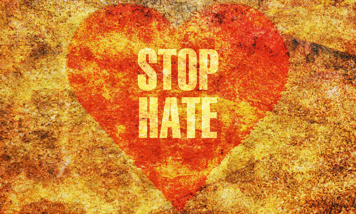 A heart shape with the words "stop hate" inside.